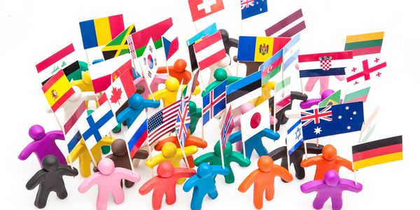 Colorful clay figures holding various international flags on a white background.