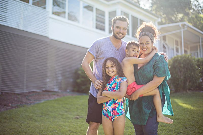 Australian aboriginal family portrait at home on a sunny day.