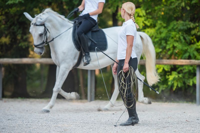 Woman giving training of horse riding to another woman.