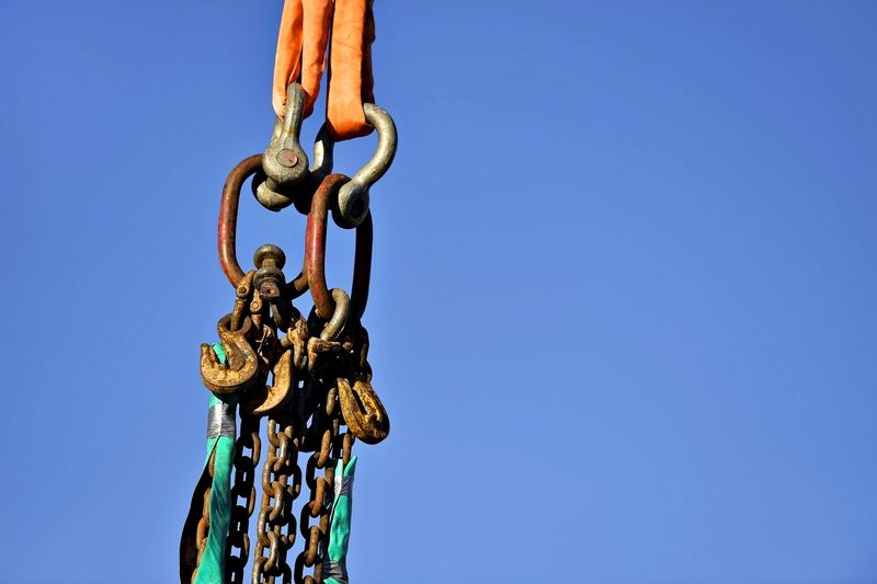 Heavy duty industrial chain hooked up on a construction crane