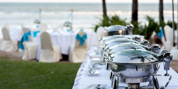 Buffet setup at an outdoor seaside event.