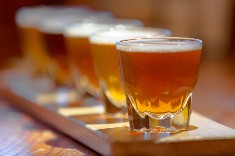 A sample of five different beers on a tasting board in a brewery.