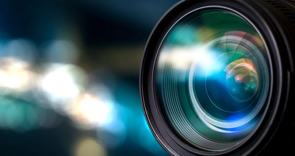 Close-up of a camera lens with reflections.