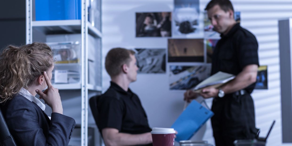 Private investigators talking in the office.