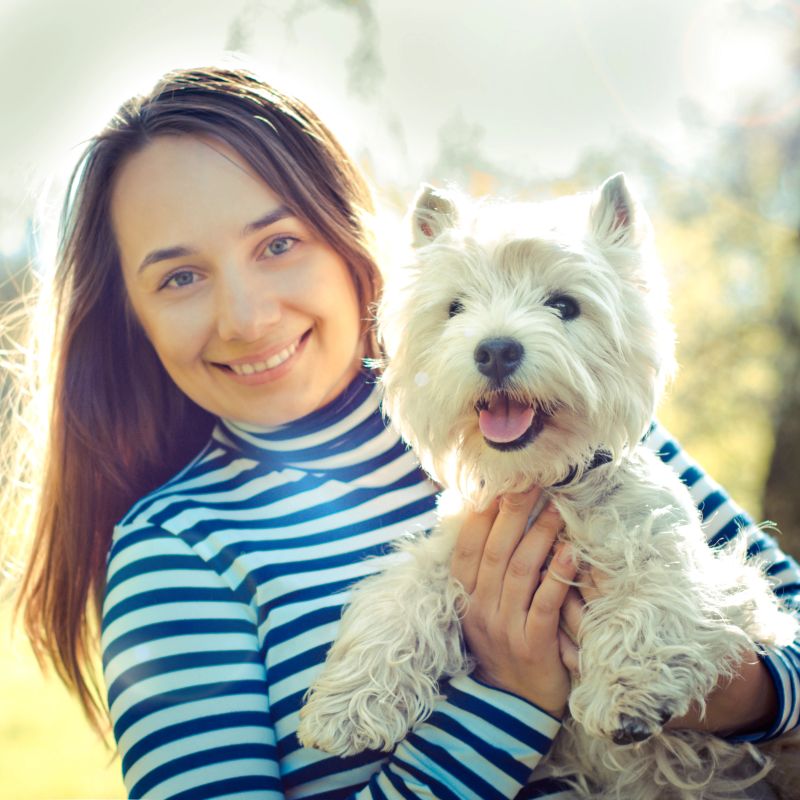 woman with west highland white terrier