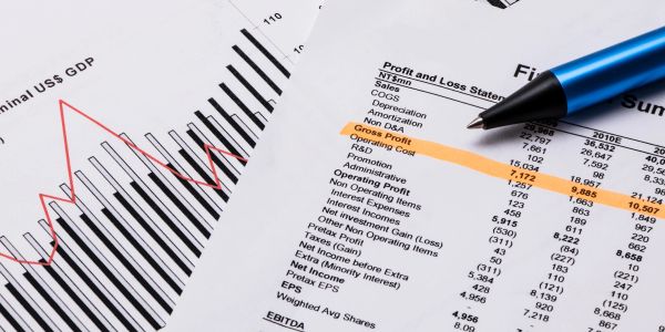 Financial report with a pen highlighting profit and loss.