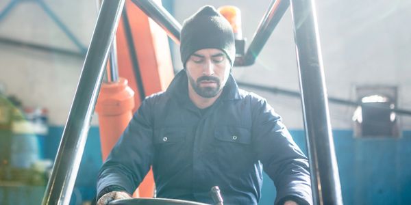 Worker operating a tractor moving soil.