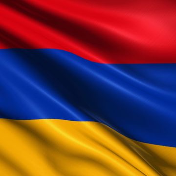 Waving flag with horizontal red, blue, and yellow stripes.