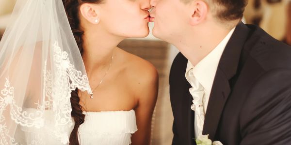 Bride and groom share a tender kiss on their wedding day.