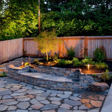 Outdoor garden area with stone steps and lighting.