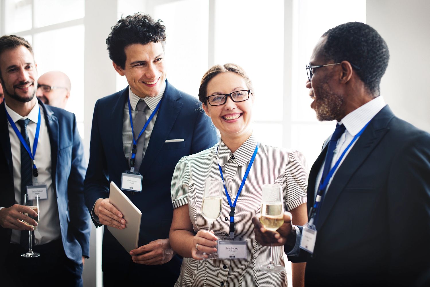 Professionals networking and enjoying drinks at a conference or event.