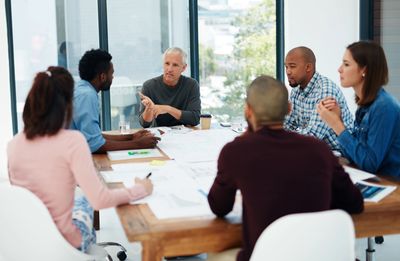 Diverse team collaborating in a bright office meeting.