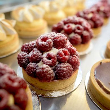 Raspberry tart with powdered sugar.