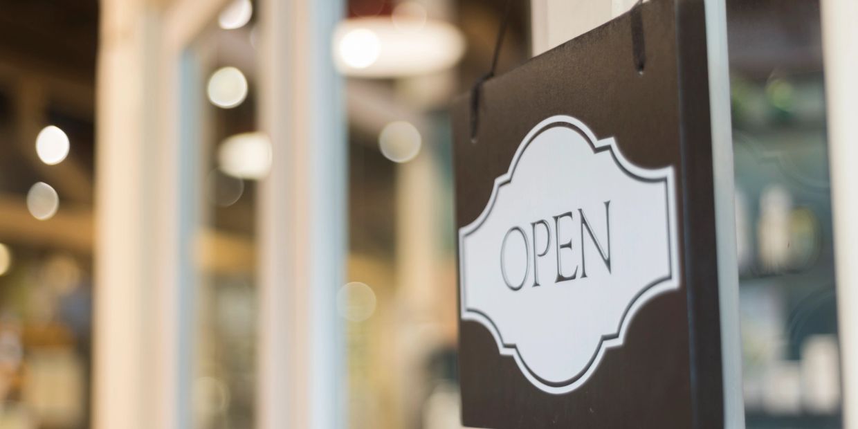 A sign with the word OPEN indicating the business is open.