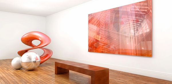 Modern art display with abstract sculpture and reflective spheres in a minimalist room.