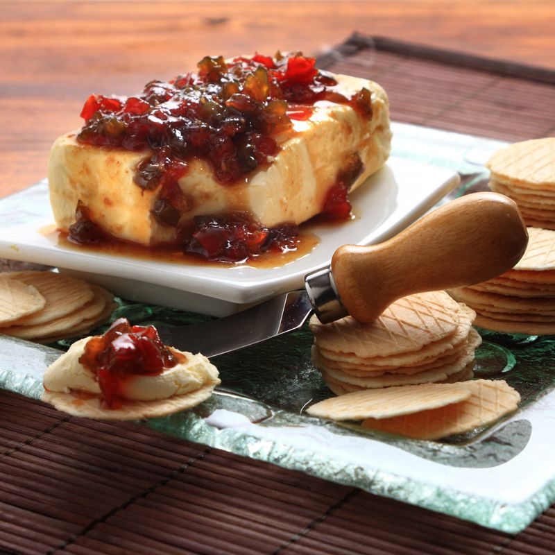 Capsicum dip served with cream cheese and water crackers