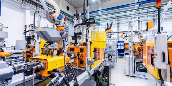 Modern industrial machines in a clean factory setting.