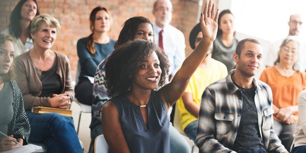 Diverse group asking questions during Q&A session with Author Teddy Heartwell.