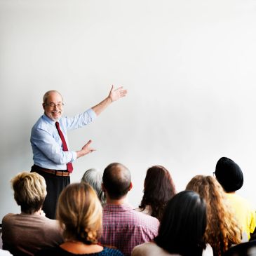 Man giving presentation to an audience in a conference room.