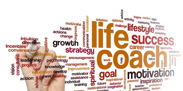 Hand drawing a life coach word cloud emphasizing success and motivation.