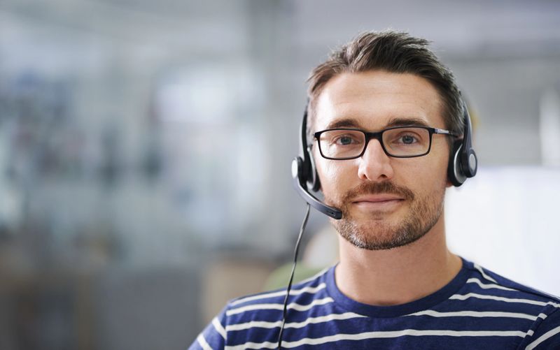 Portrait of a handsome young businessman wearing a headset in the office