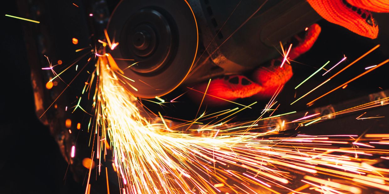 Close-up of a grinder producing bright, flying sparks.