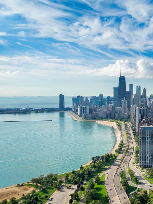 Aerial view of Chicago skyline with Lake Michigan and lakeshore road.