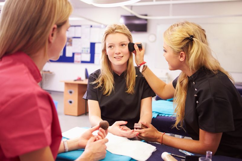 Teacher Helping Students Training To Become Beauticians