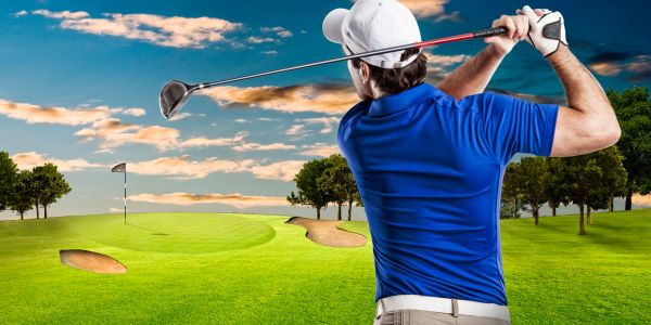 Man playing golf on a sunny day.