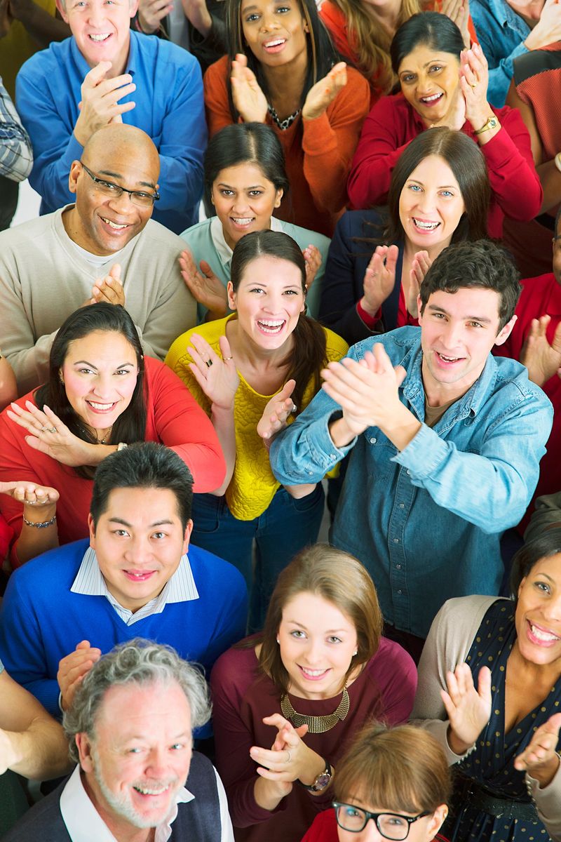 Portrait of happy crowd clapping