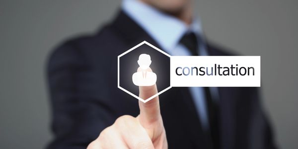 Businessman pressing a virtual consultation icon on screen.