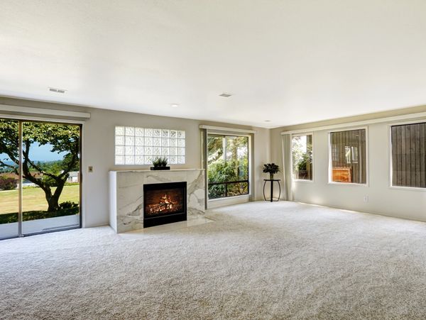 Spacious living room with large windows, fireplace, and scenic outdoor view.