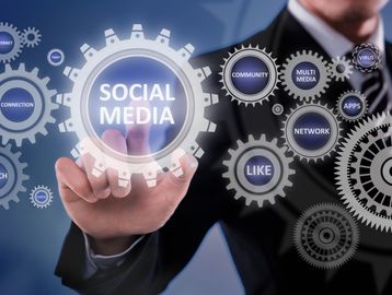 Businessman interacting with social media gears.