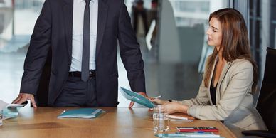 Businessman and businesswoman discussing documents in a modern office.