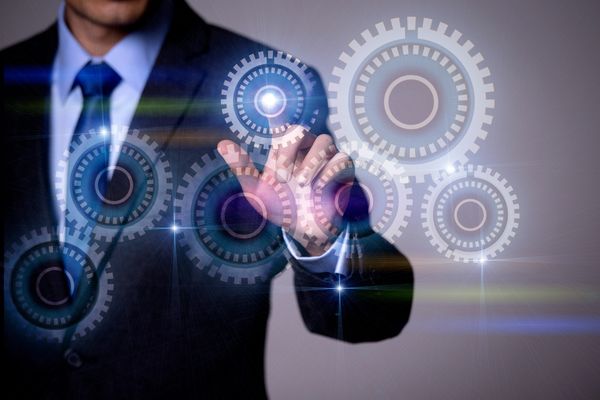 Hand interacting with glowing SAP and module icons on a digital interface.