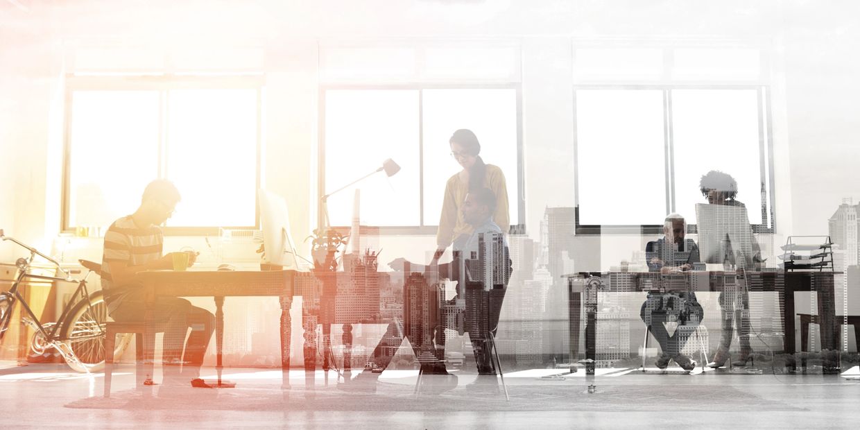 People collaborating in a modern office with a cityscape overlay.