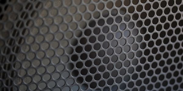 Close-up of a perforated metal surface.