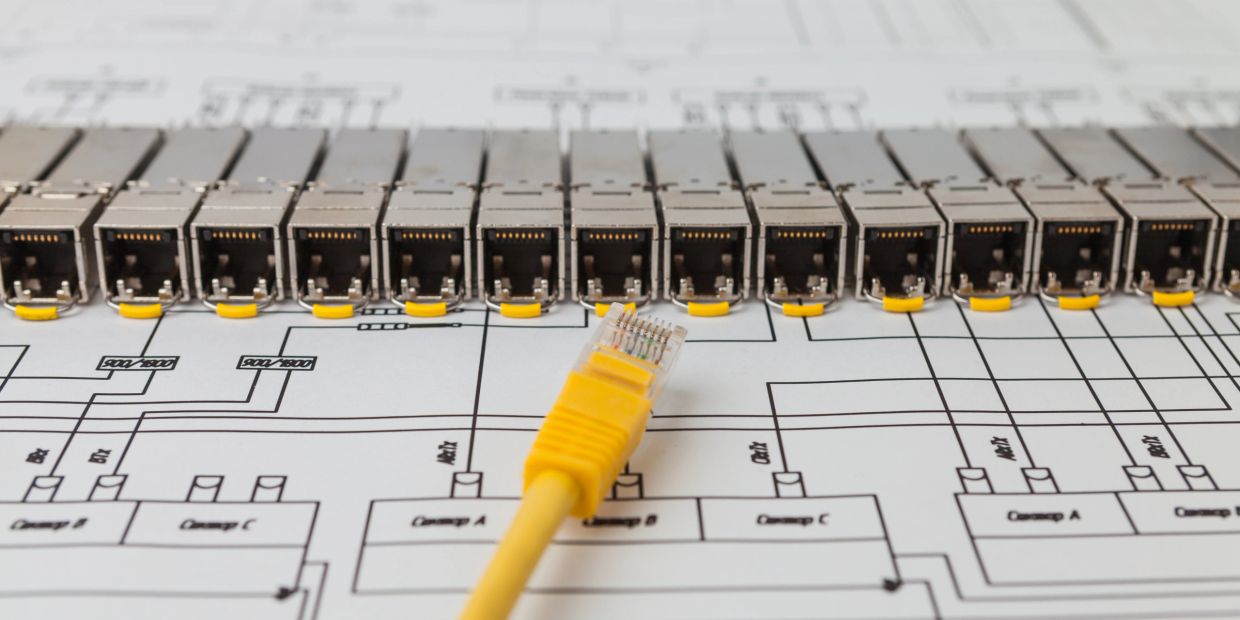 Yellow Ethernet cable and connectors on a wiring diagram.