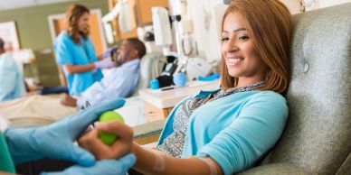 Woman smiling during blood donation.
