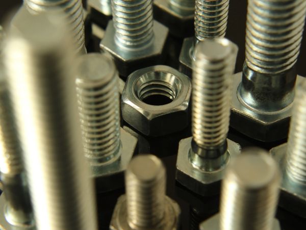Close-up of nuts and bolts arranged together.