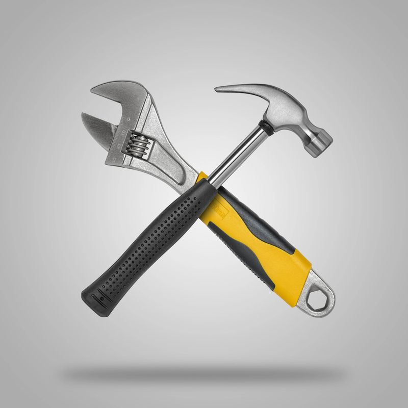 Crossed hammer and wrench. Tools for carpentry work.