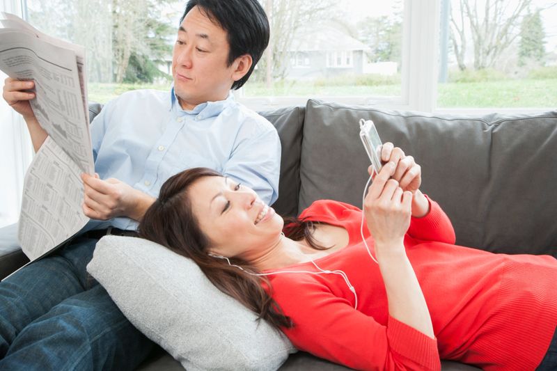 Middle-aged couple relaxing on sofa