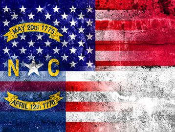 Historical North Carolina flag with dates and stars.