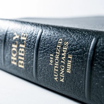 Close-up of a black leather-bound King James Bible with gold lettering.