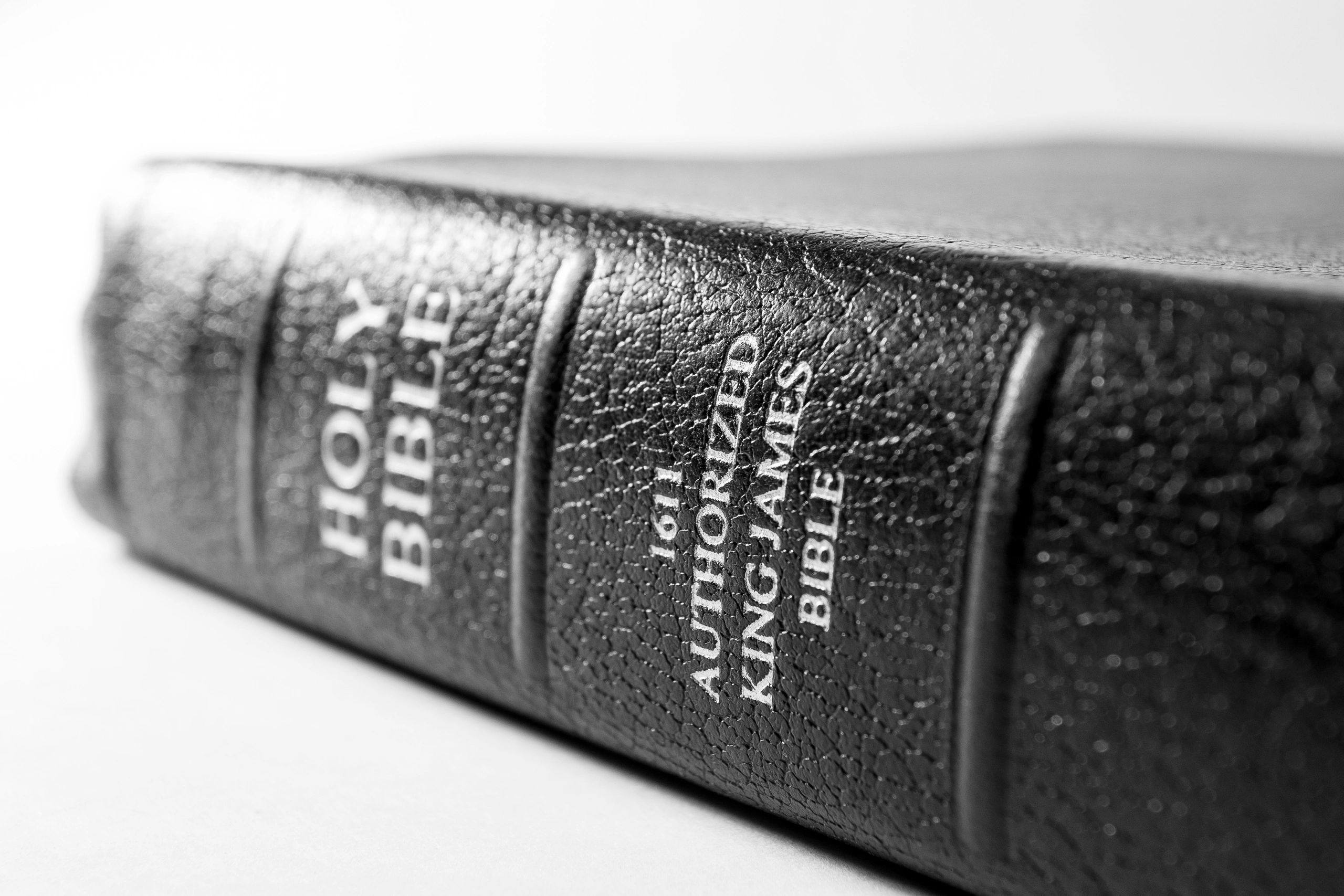 Close-up of a black leather-bound Holy Bible with gold lettering.