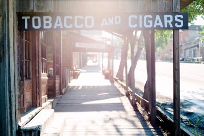 Old wooden porch with a Tobacco and Cigars sign.