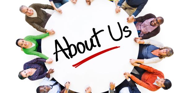 Diverse group holding hands around a table with 'About Us' written.