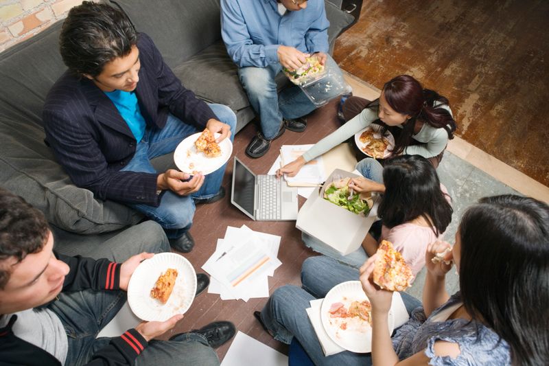 Co-workers having working lunch, high angle view