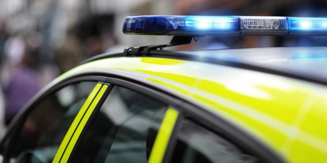 Close-up of police car with flashing lights.