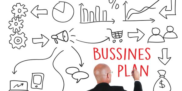 Man writing 'BUSSINES PLAN' on a whiteboard with business icons.